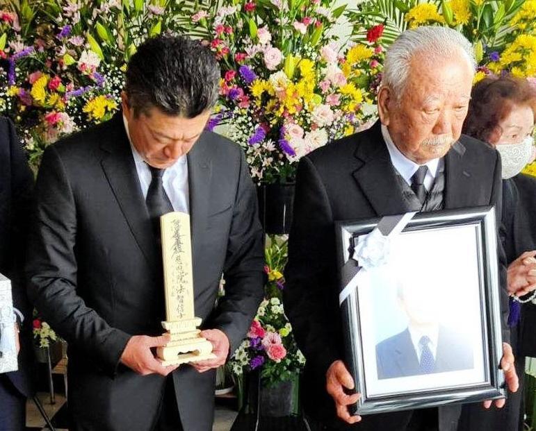 　入来智さんの告別式に参列する弟の祐作氏（左）右は父の嘉門さん