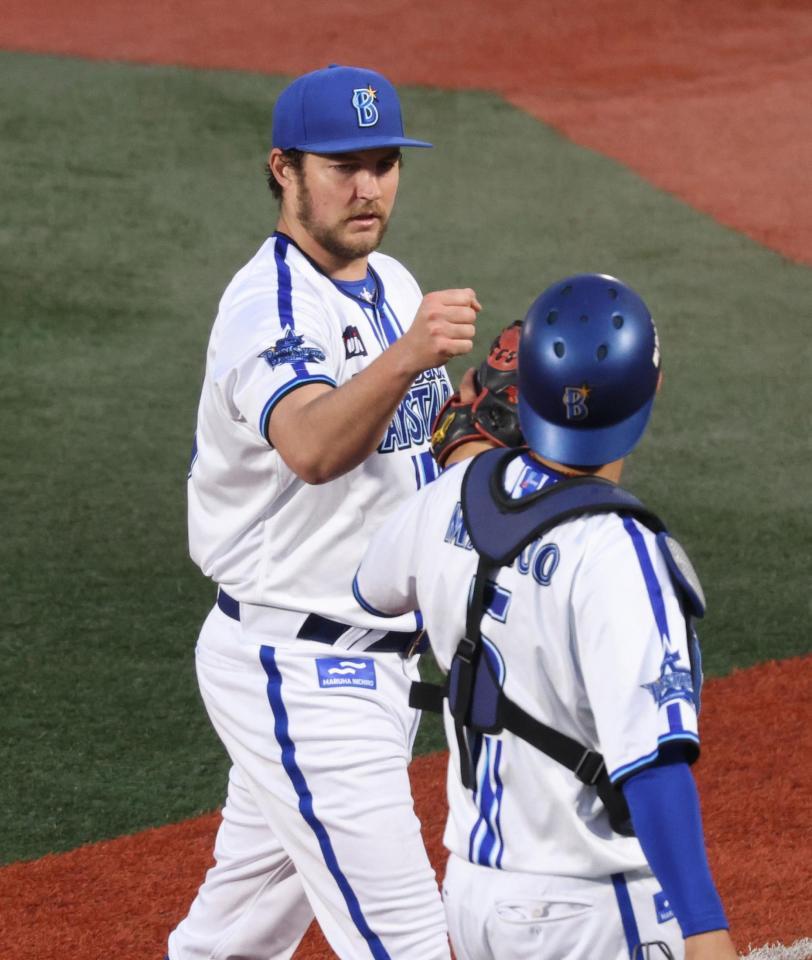 　２回表の投球を終え、松尾（手前）とタッチするバウアー