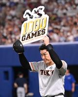 　通算１０００試合出場を達成しボードを掲げる梶谷