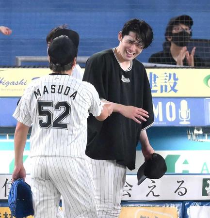 　試合後、益田（左）からウイニングボールを渡されて笑顔を見せる佐々木朗