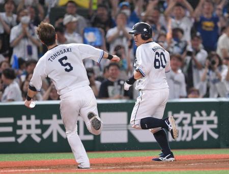 　９回、センターへサヨナラ適時二塁打を放ち、ペットボトルシャワーから逃げ惑う中村（右）＝撮影・伊藤笙子