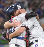 　４安打完封で６勝目を挙げ、古賀（左）と抱き合うサイスニード（撮影・佐藤厚）