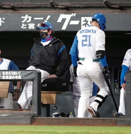 　６回、空振りの三振に倒れベンチに戻る清宮。左は新庄監督