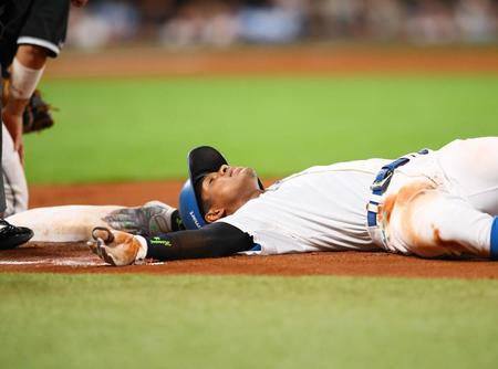 　４回、適時打を放ち、タッチをかいくぐり仰向けになる万波（撮影・中島達哉）