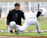 　笑顔を浮かべて、佐々木（右）に厳しく指導する阿部監督（撮影・西岡正）