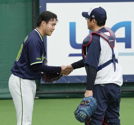 　投球練習を終え、古田臨時コーチ（右）と握手するヤクルト・松本＝浦添