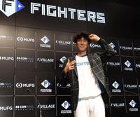 　支配下登録され、新庄監督からプレゼントされたスーツとサングラスを身につけ記念撮影に応じる福島（撮影・中島達哉）