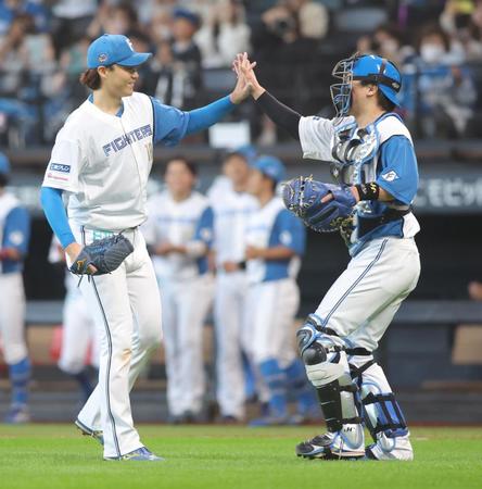 　９回完投勝利をあげ、タッチを交わす山崎（左）と伏見（撮影・中島達哉）