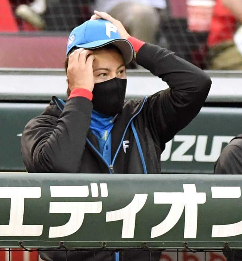 　ベンチで頭をかく新庄監督