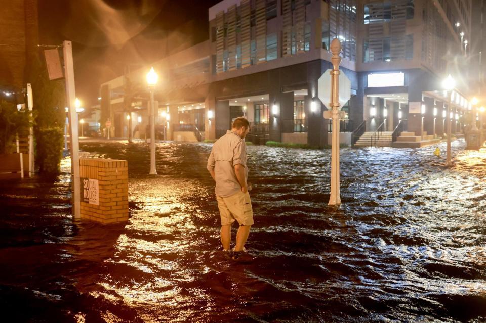 　ハリケーン「ミルトン」の影響で冠水した道を歩く男性＝９日、米南部フロリダ州（ゲッティ＝共同）