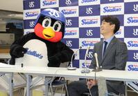 　会見中、青木宣親ＧＭ特別補佐（右）とひそひそ話をするつば九郎（撮影・西岡正）