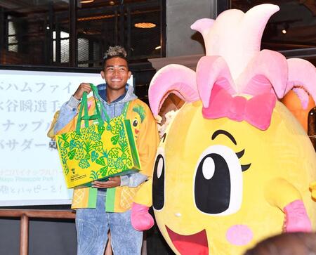 　ナゴパイナップルパークの人気キャラクター「ピーチちゃん」からプレゼントを受け取り笑顔の水谷（撮影・開出牧）