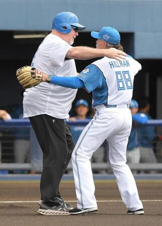 　始球式を終え、ハグするヒルマン元監督（右）とマット・ウィンタース氏（撮影・佐藤厚）