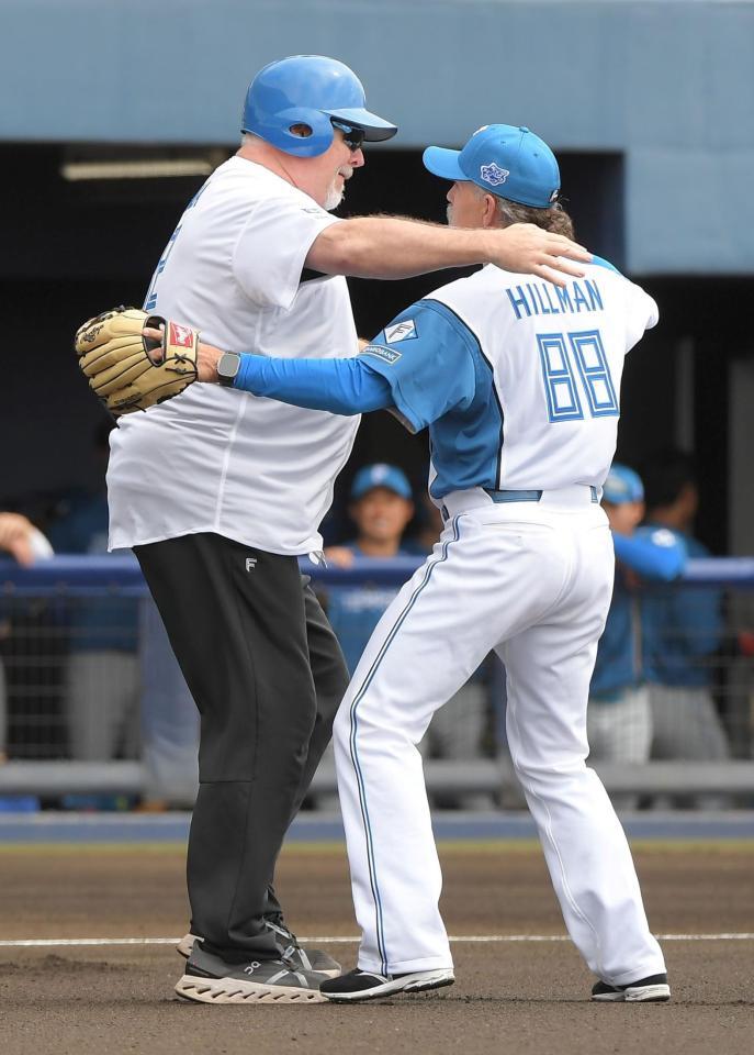 　始球式を終え、ハグするヒルマン元監督（右）とマット・ウィンタース氏（撮影・佐藤厚）