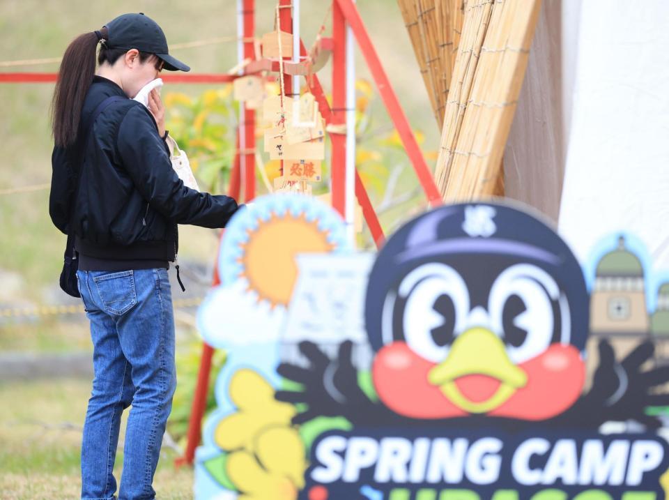 　タオルで顔を覆いながらつば九郎神社の絵馬を見つめるファン（撮影・吉澤敬太）