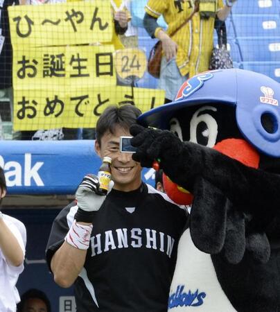 　つば九郎に飲料水の誕生日プレゼントをもらい一緒に写真にを撮る桧山（２０１２年７月）