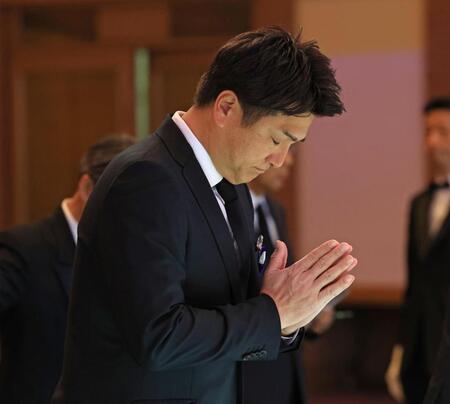 　献花し、手を合わせる高橋由伸氏（読売新聞社提供）