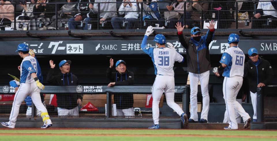 ６回、逆転満塁本塁打を放った水野（左端）らをハイタッチで迎える新庄監督（右から３人目）＝撮影・中島達哉