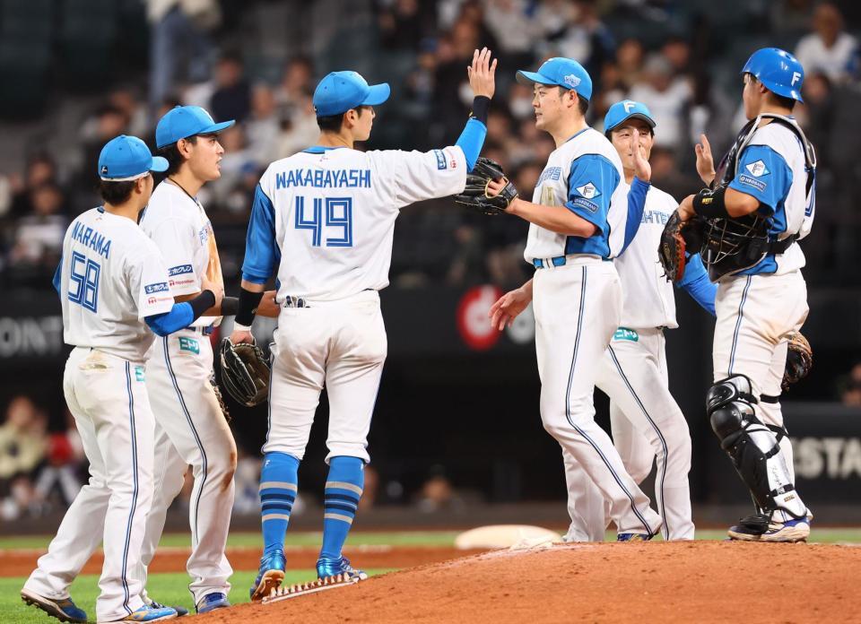 　ヤクルトに勝利をあげ、タッチを交わす野村（左から２人目）ら日本ハムナイン（撮影・中島達哉）