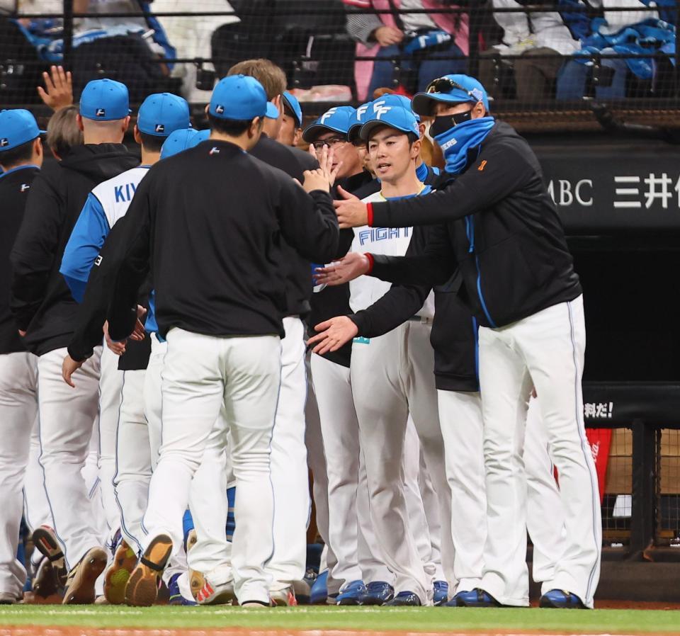 　ヤクルトに勝利をあげ、ナインを迎える新庄監督（右）＝撮影・中島達哉