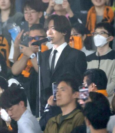 　ネット裏客席の中央で国歌斉唱するＤＡＩＧＯ（撮影・西岡正）