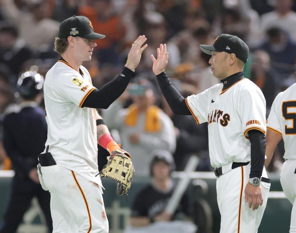 　勝利に貢献し、阿部監督（右）とタッチを交わすキャベッジ（撮影・西岡正）