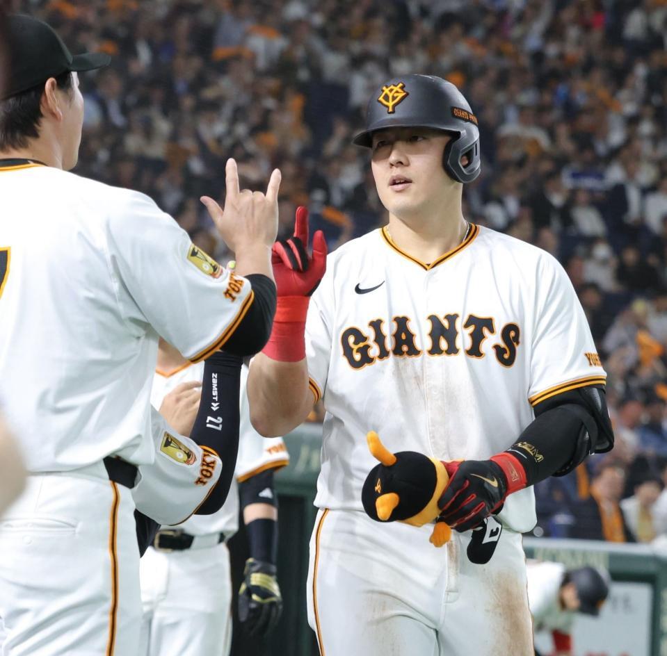 　３回、２ランを放ち、ナインとタッチを交わす岡本（撮影・西岡正