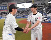 　握手する種市（右）と寺地のバッテリー（撮影・佐藤厚）