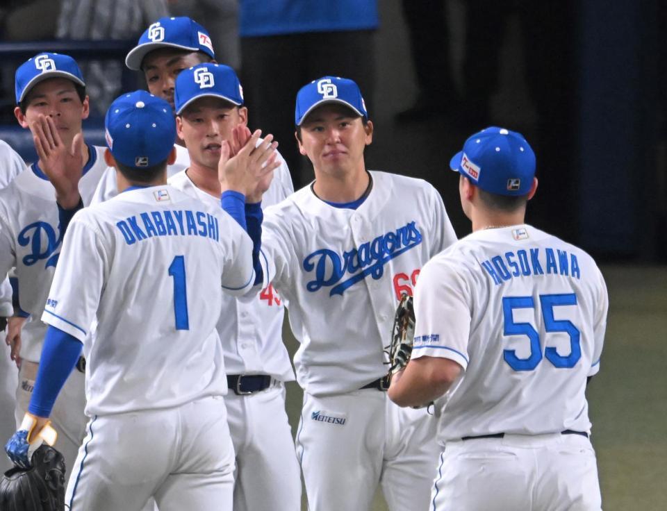 　プロ初勝利を飾り、ナインを出迎える三浦（中央）＝撮影・飯室逸平