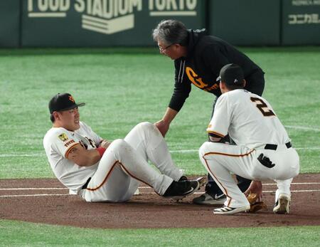 　１回、犠打の中野と送球を受けた際に交錯し左腕を痛めた岡本（撮影・金田祐二）