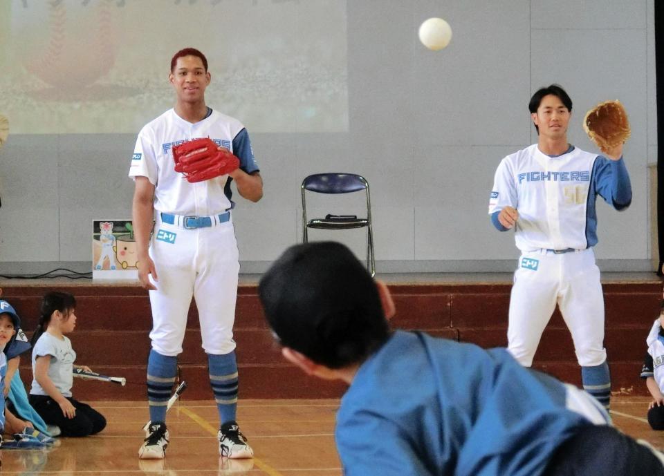 　児童とキャッチボールをする万波（左）と細川