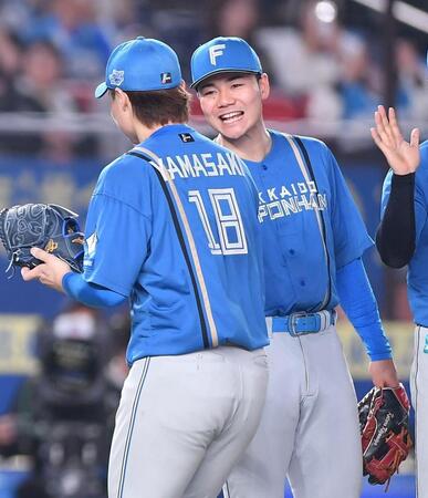 　完封で今季２勝目を挙げた山崎（手前）を祝福する清宮幸（撮影・開出牧）