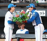 　宮西（左）に花束を渡して祝福する新庄監督（撮影・中島達哉）