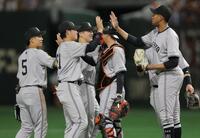 　４連勝でタッチを交わす泉口（中央）ら巨人ナイン（撮影・西岡正）