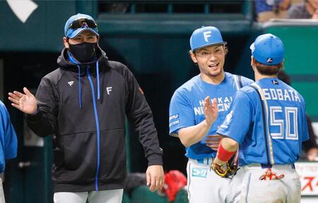 　新庄監督（左）とナインを迎える伊藤（中央）