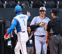 　新庄監督（左）とのメンバー表交換を終え、笑顔を見せる藤川監督（中央）＝撮影・中島達哉