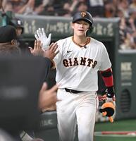 　６回、先制の左越えソロを放ち、ナインとタッチを交わす増田陸（撮影・開出牧）