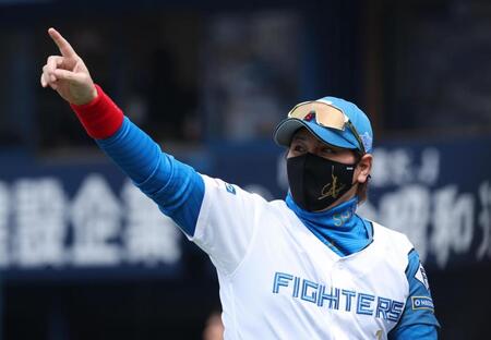 　メンバー表交換を終えスタンドを指さす新庄監督（撮影・金田祐二）