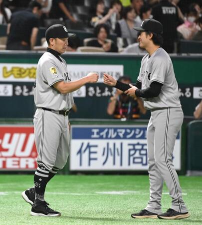 　先発で初勝利の西舘（右）は阿部監督とグータッチする