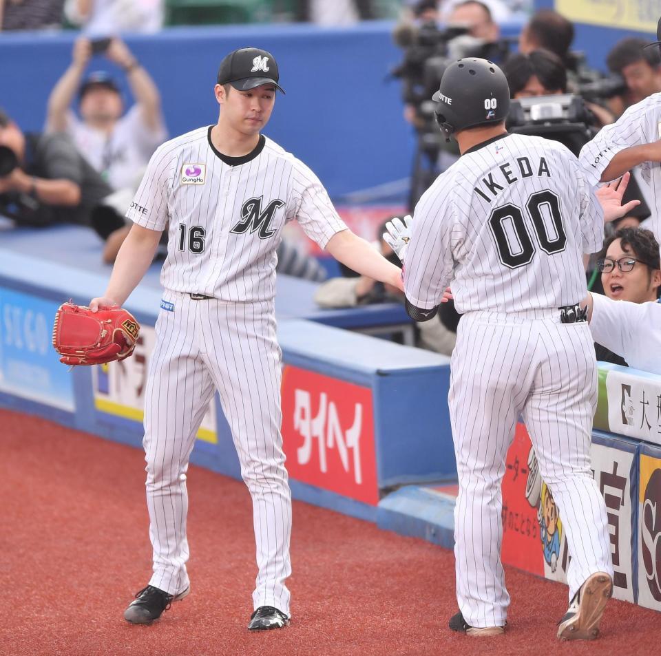 　１回、先制の左越えソロを放った池田（右）とタッチを交わす種市（撮影・開出牧）