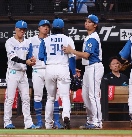 　７回途中から登板し、無失点で抑えた堀（中央）を迎える伊藤（右）＝撮影・中島達哉