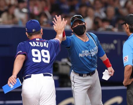 　井上監督（左）とタッチをする新庄監督（撮影・佐々木彰尚）