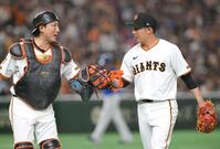 　初回を無失点に抑え、小林（左）とタッチする赤星（撮影・伊藤笙子）