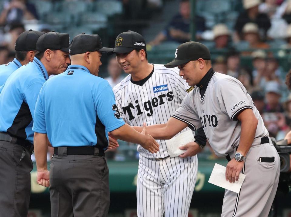 　メンバー表交換を終え、審判団と握手を交わす（右から）阿部監督、藤川監督（撮影・北村雅宏）