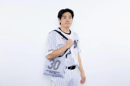 　メッシュショルダーバッグを手にする安田（球団提供）