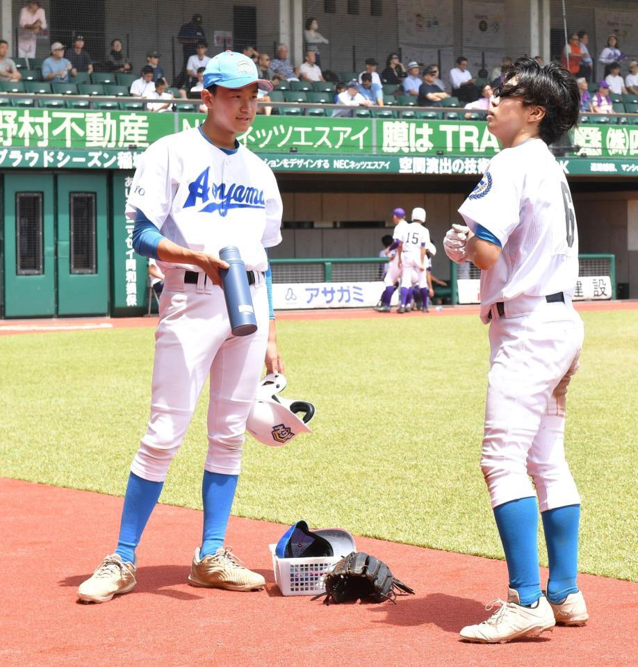 　７回の攻撃前、関谷佳彦（右）に水を手渡す青山学院・二岡択実（撮影・持木克友）