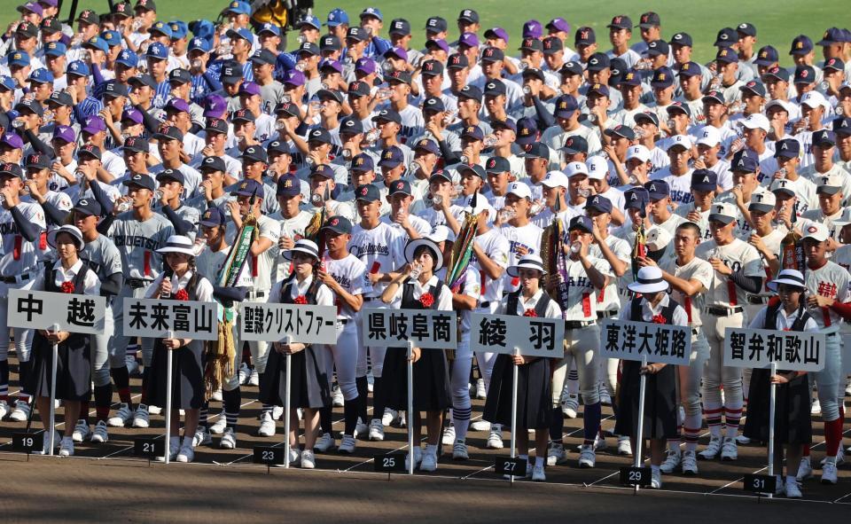 　開会式途中で水分を補給する選手ら