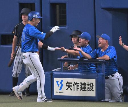 　５回、ソロ本塁打を放った山本（左）を迎える三浦監督