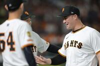 　２回、勇気あるプレーでナインに祝福されるリチャード（撮影・西岡正）