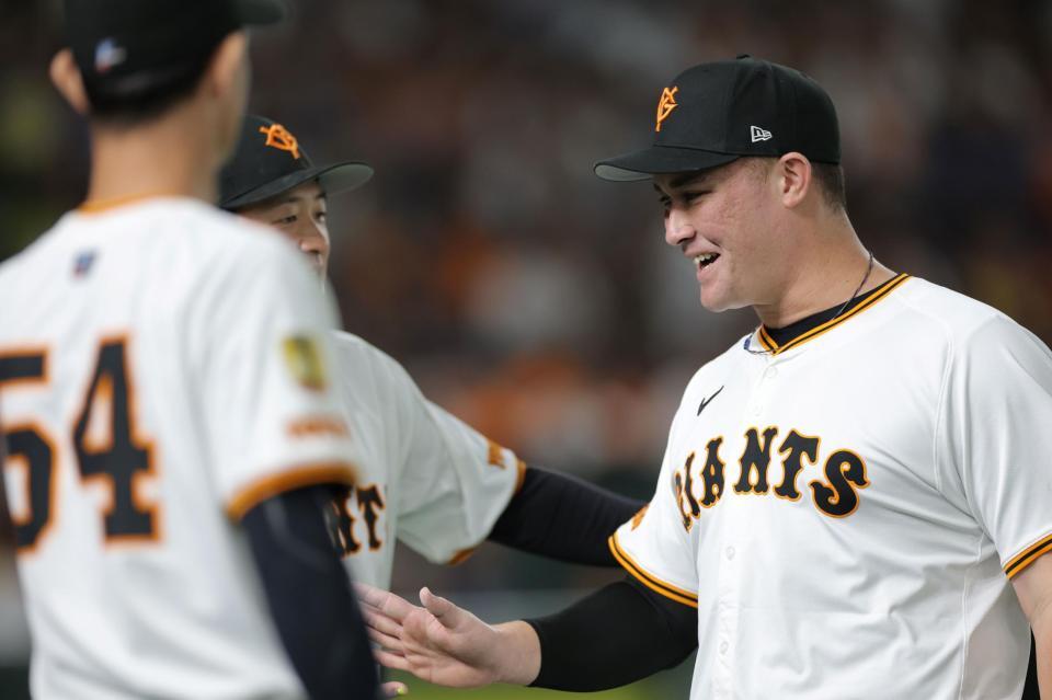 　２回、勇気あるプレーでナインに祝福されるリチャード（撮影・西岡正）